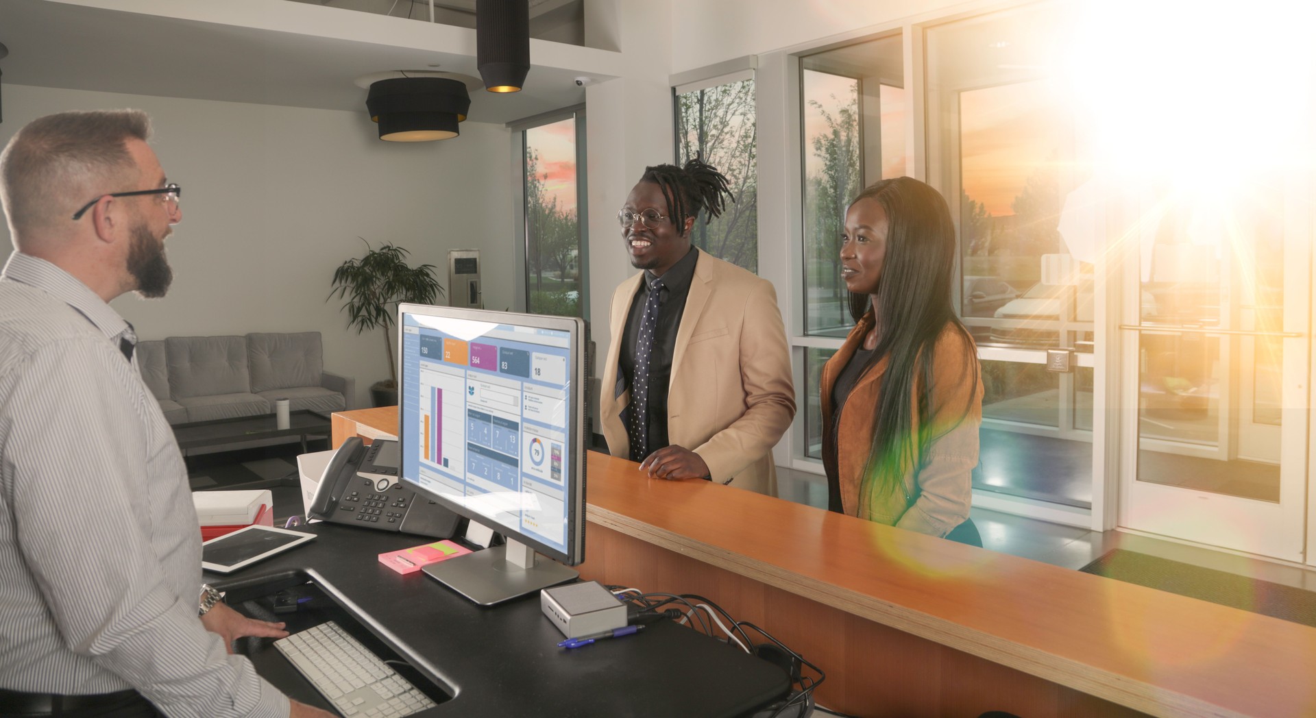 Couple checking in to reception desk